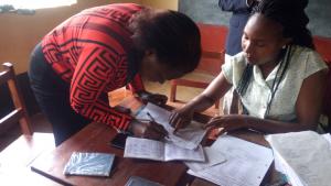 Community Banking - A customer at receiving funds at a table banking session